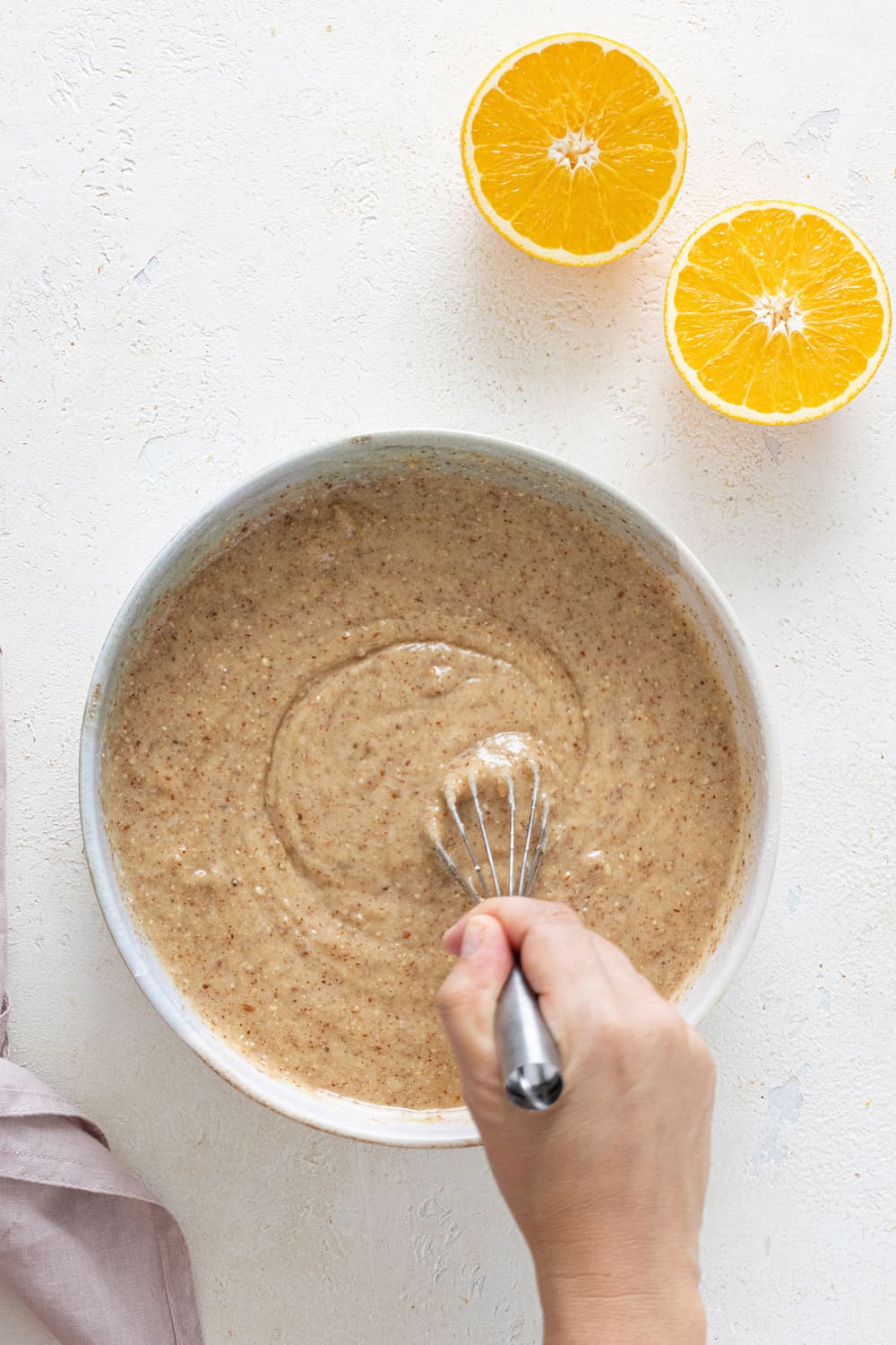 Whisking almond orange cake batter until smooth