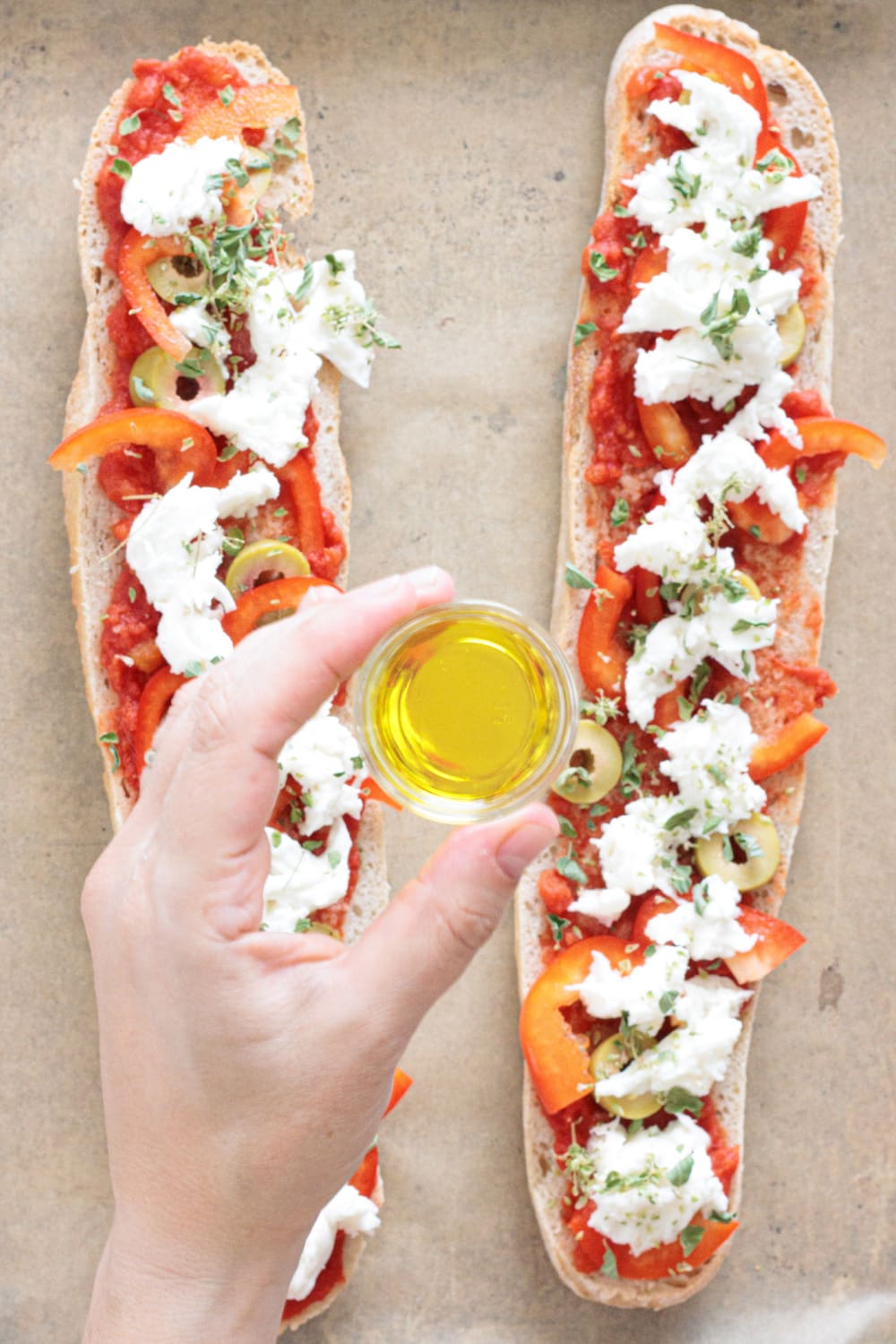 Finish with dried oregano and a drizzle of olive oil before baking