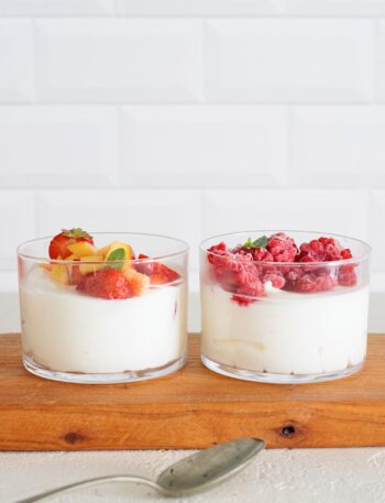 Keto cheesecake cups with strawberries, peaches, and raspberries