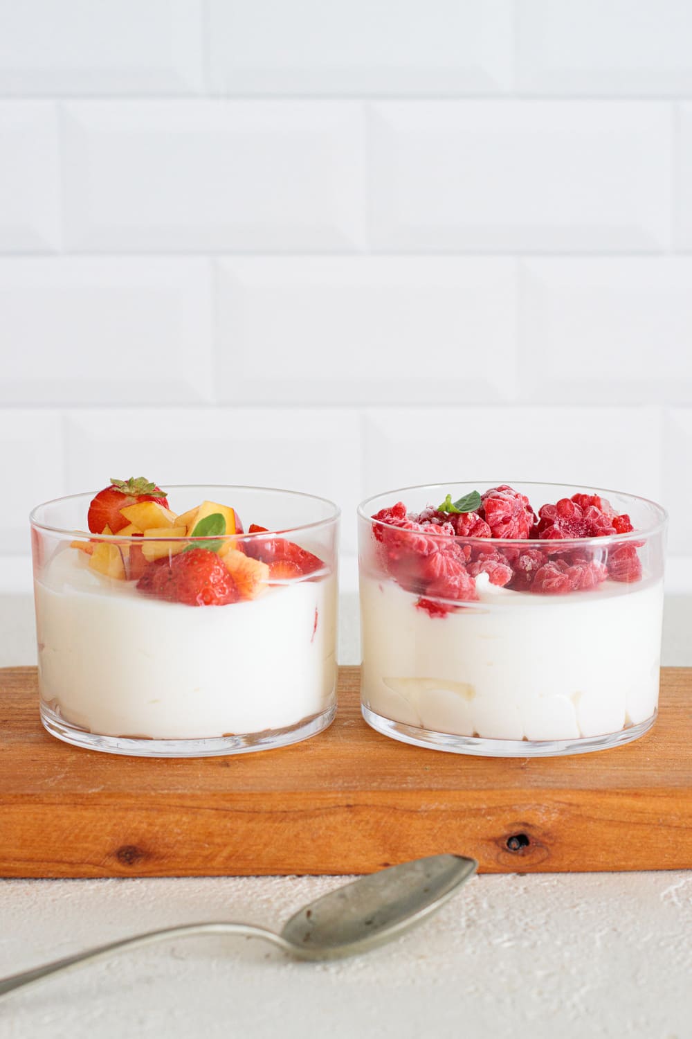 Keto cheesecake cups with strawberries, peaches, and raspberries