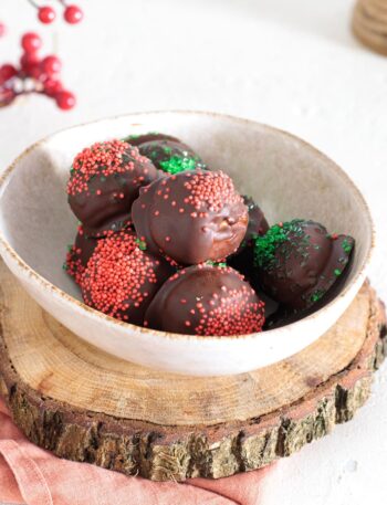 Rich chocolate peanut butter balls decorated with colorful sprinkles, ready to enjoy.
