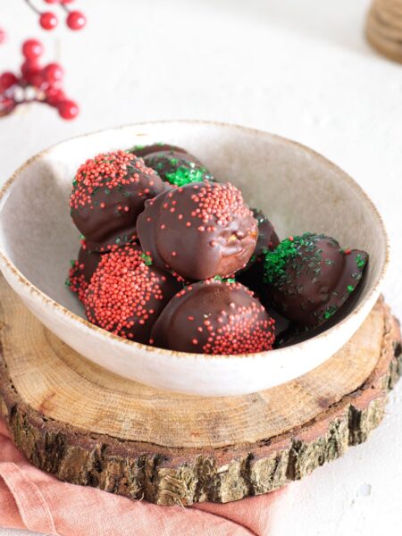 Rich chocolate peanut butter balls decorated with colorful sprinkles, ready to enjoy.