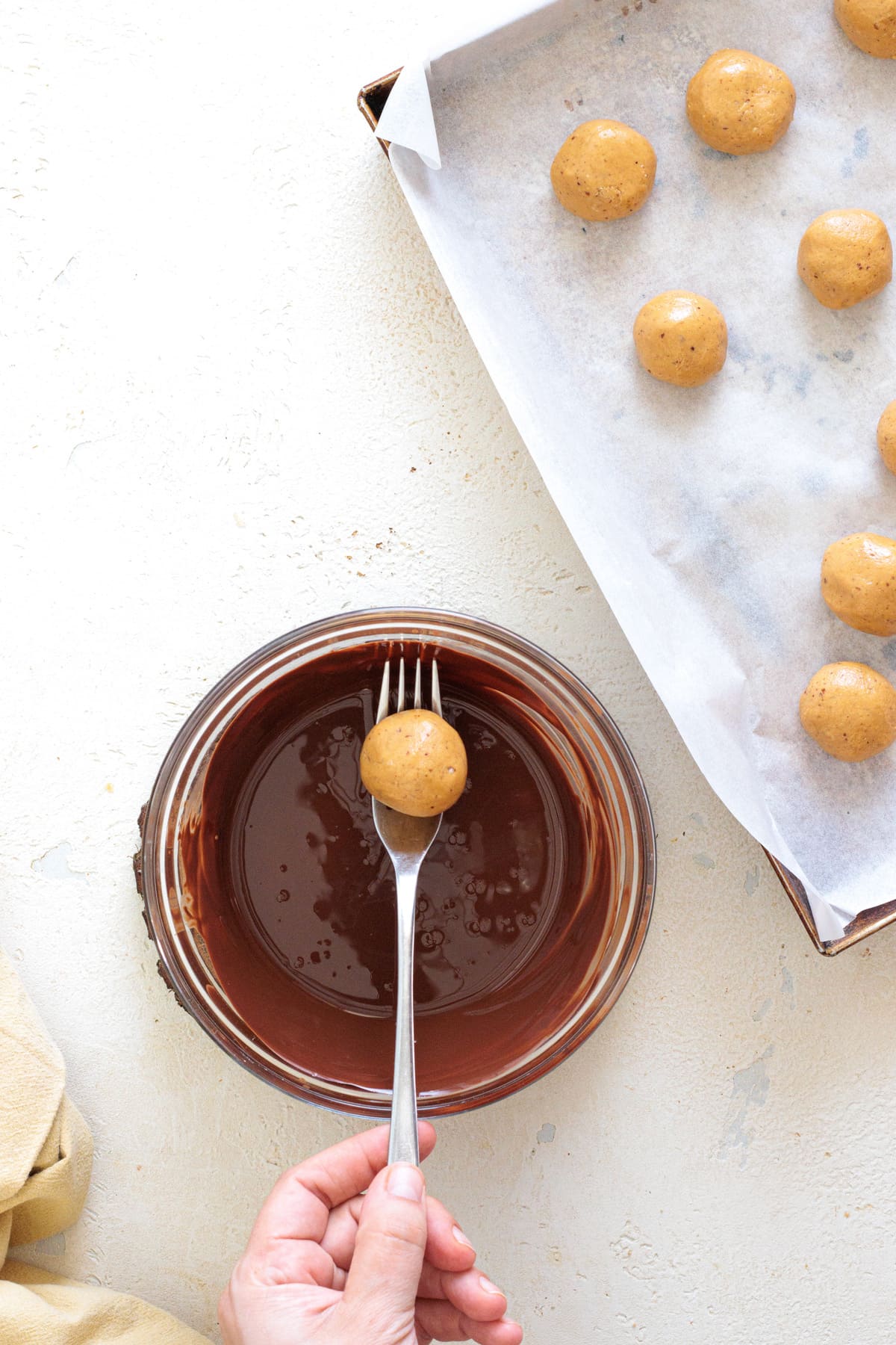 Coat each peanut butter ball in melted dark chocolate until fully covered.