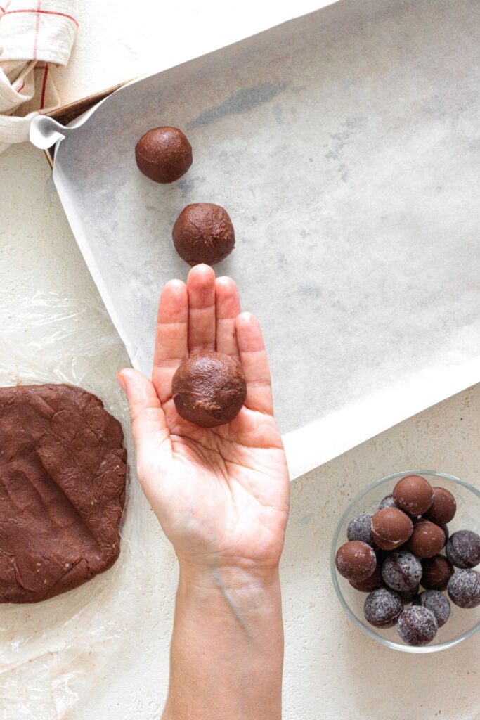 Cookie dough wrapped around frozen chocolate and rolled into a ball