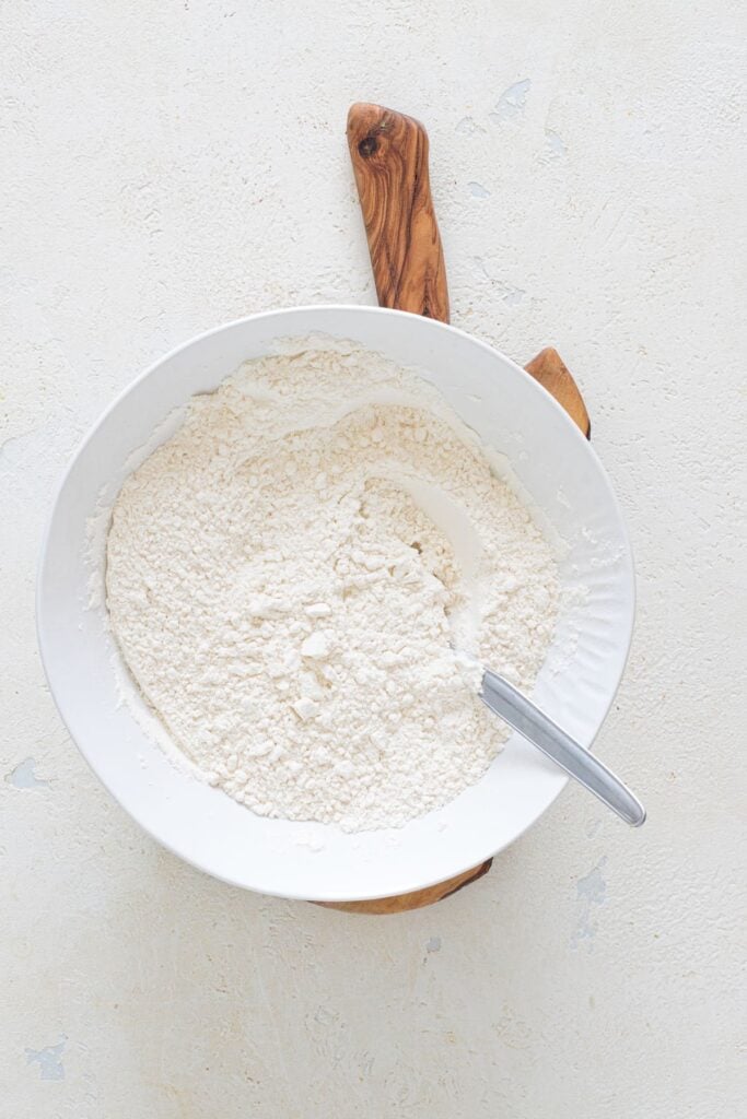 Flour, baking powder, and salt mixed in a bowl