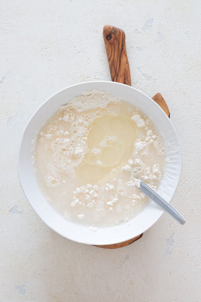 Water and olive oil added to flour mixture for 3-ingredient bread