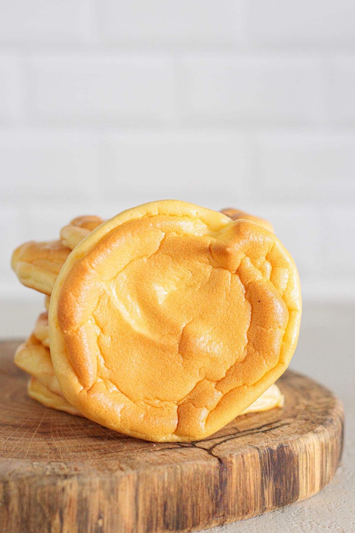 Golden brown keto cloud bread stack on wooden board