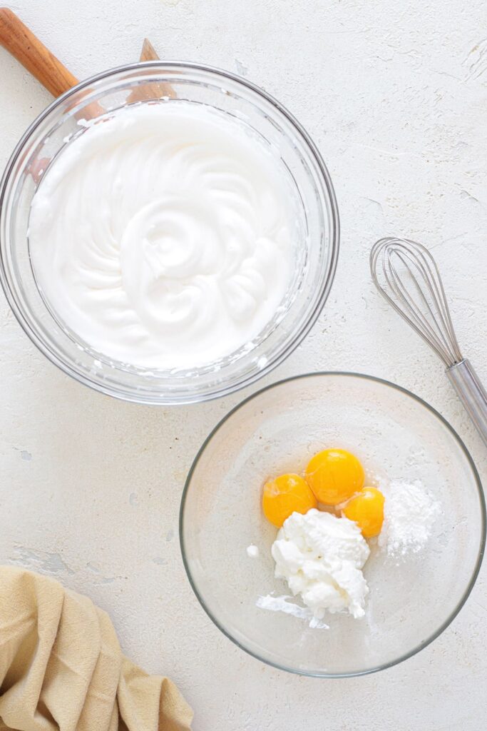 Stiff egg whites whipped with vinegar and yolks mixed with Greek yogurt