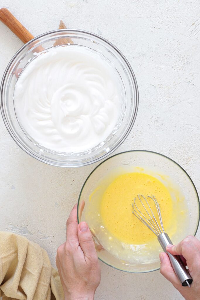 Whisked egg yolk mixture beside stiff whipped egg whites for cloud bread