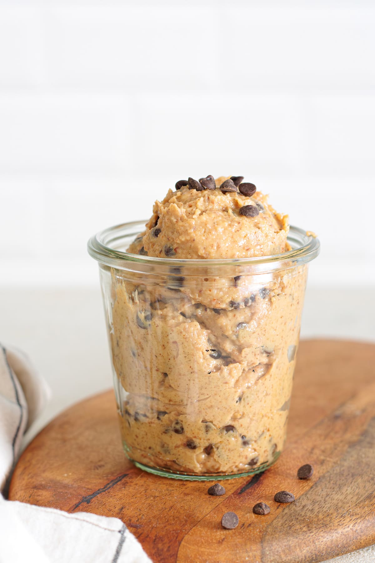 Glass jar filled with creamy Greek yogurt cookie dough, topped with chocolate chips.