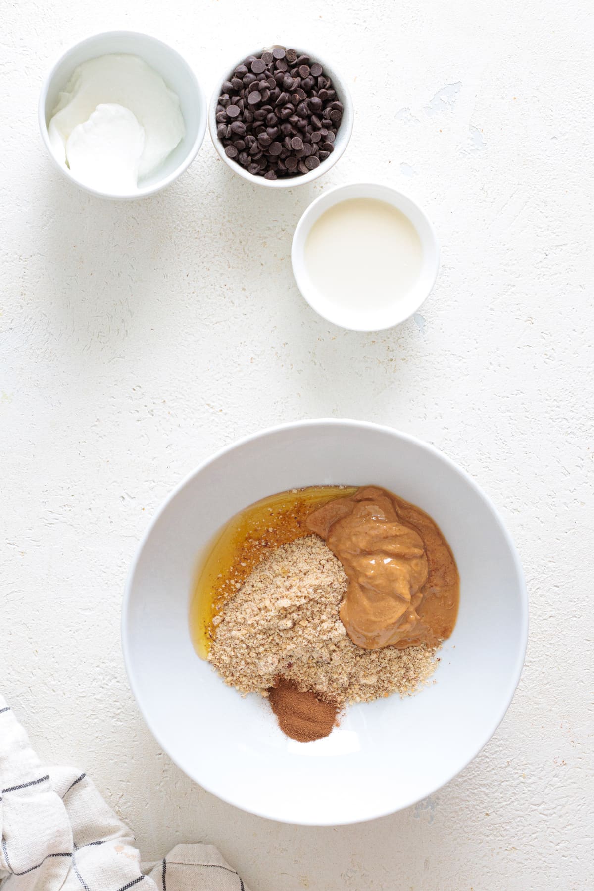 Creamy peanut butter spooned into the bowl with the dry mix.