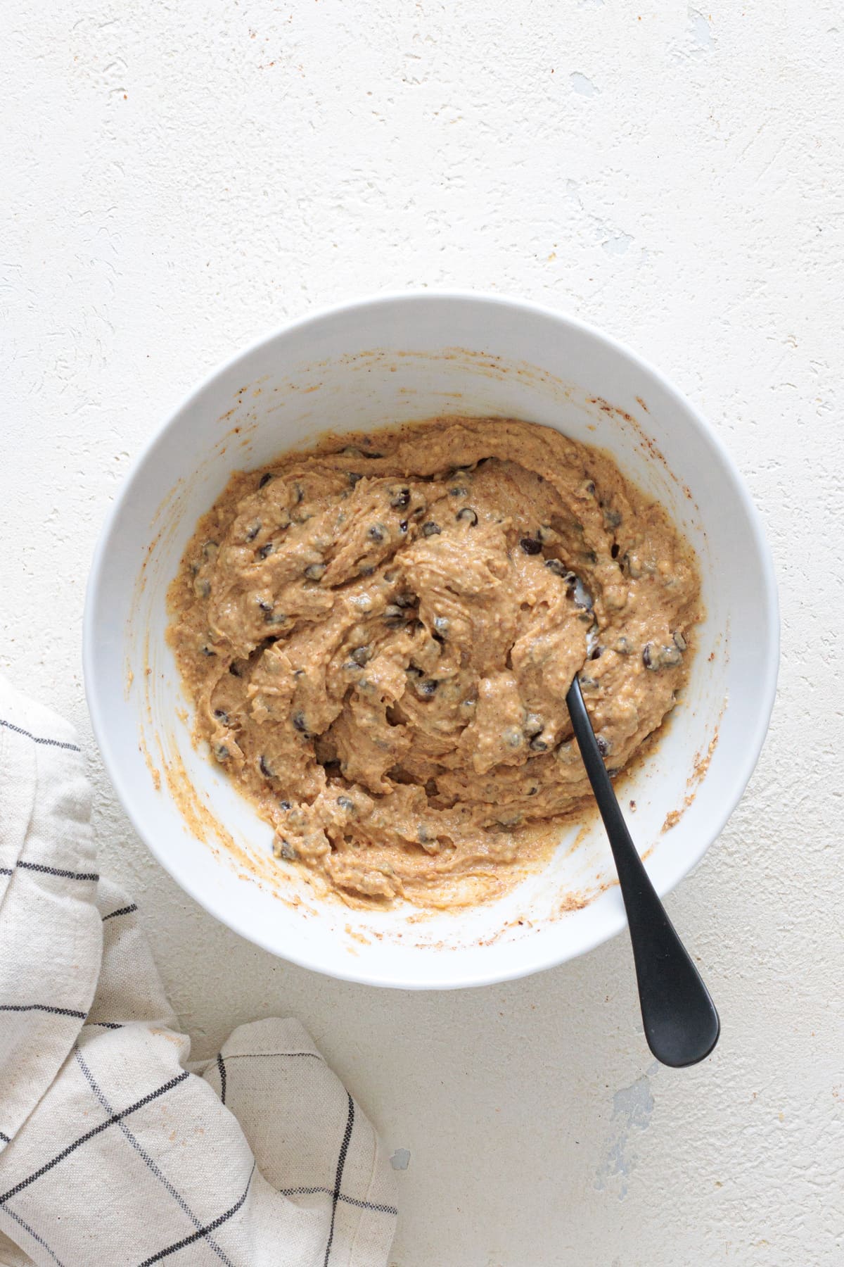 Thick, creamy cookie dough with chocolate chips evenly mixed.