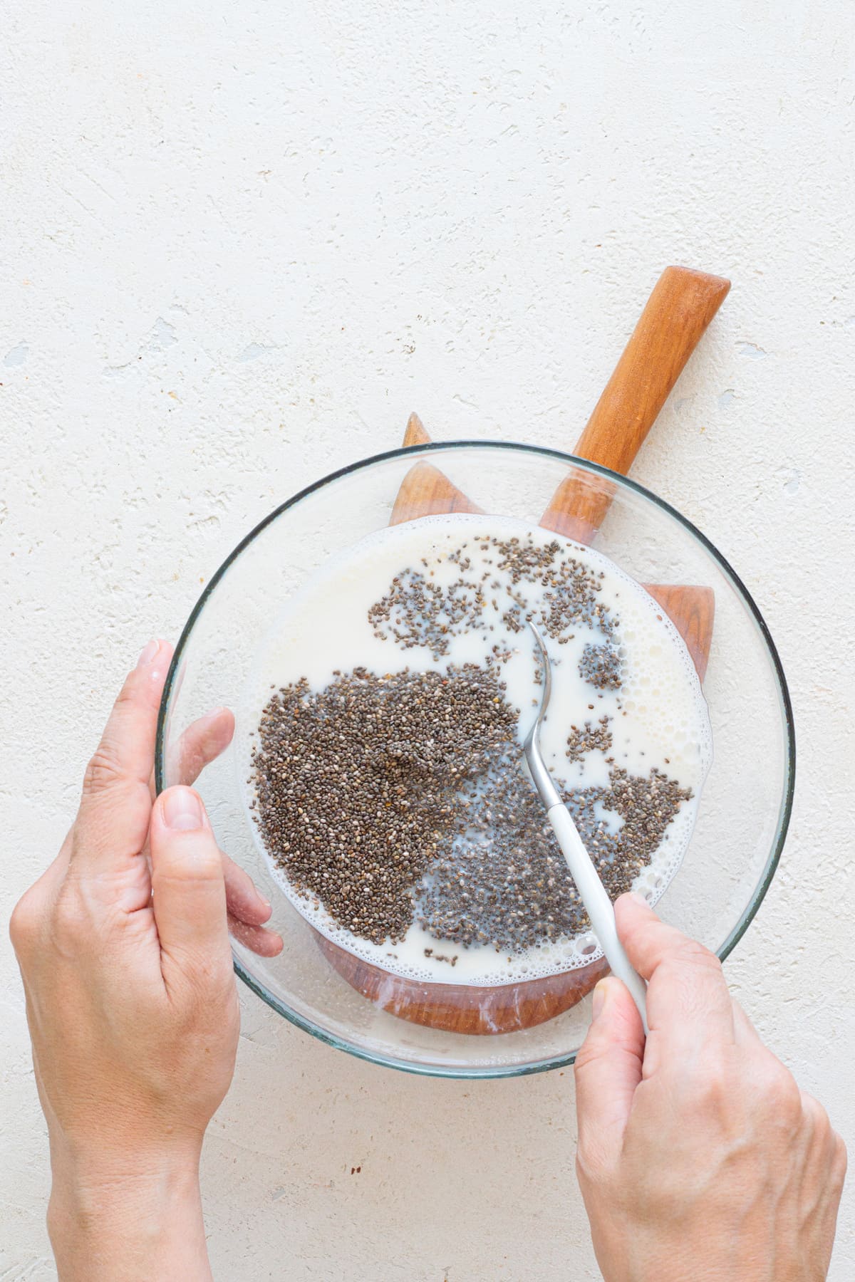 Adding chia seeds to the sweetened milk.