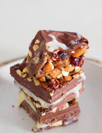 Close-up of homemade nut goodie bars with a smooth vanilla center and nut topping.