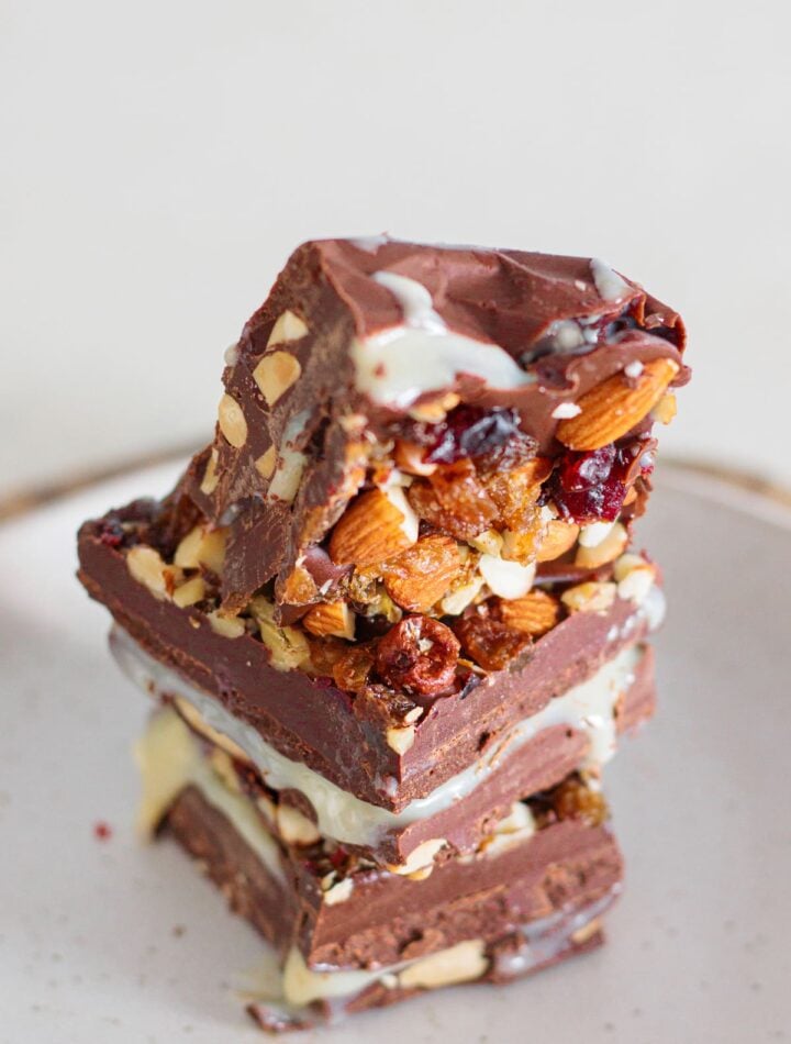 Close-up of homemade nut goodie bars with a smooth vanilla center and nut topping.
