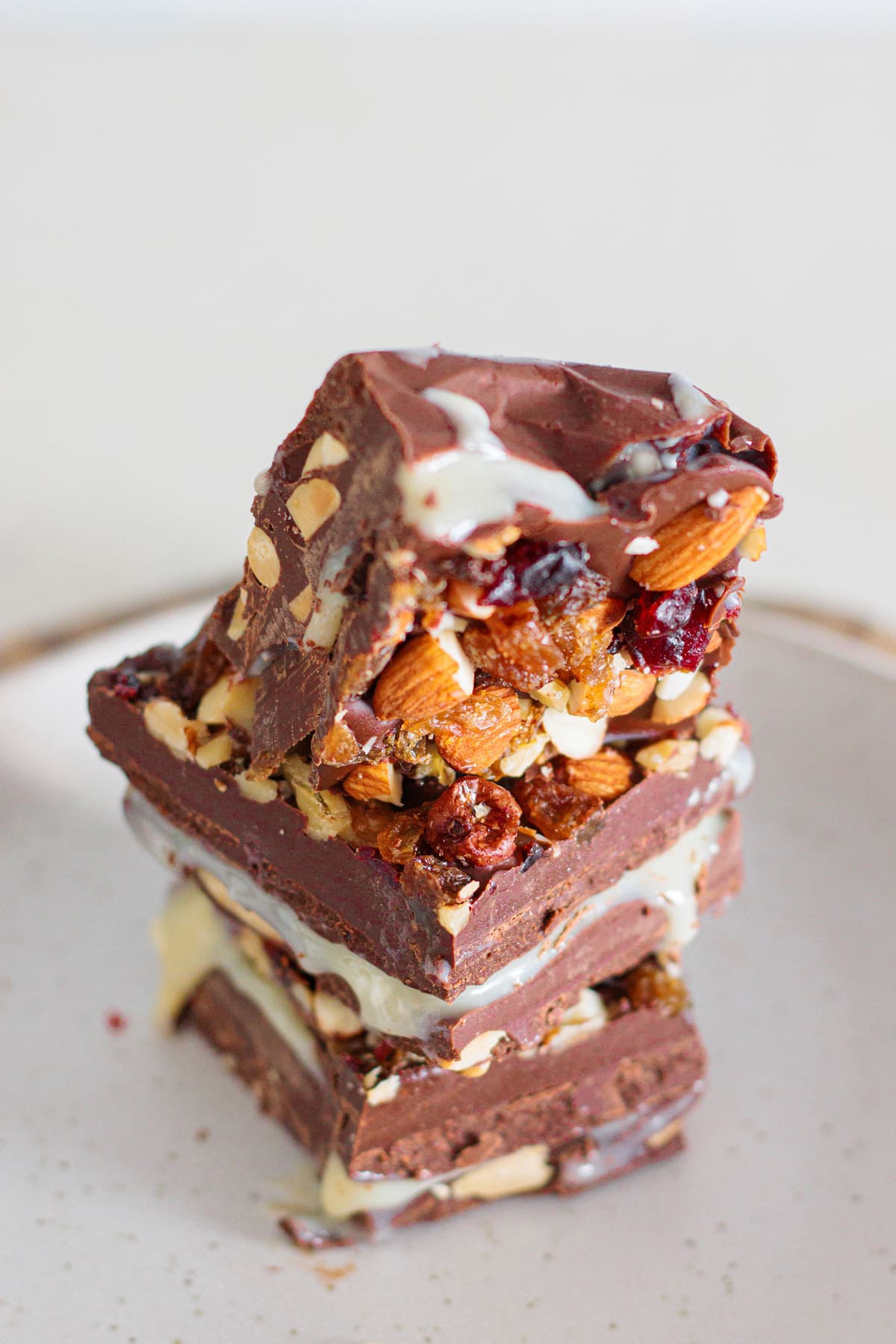 Close-up of homemade nut goodie bars with a smooth vanilla center and nut topping.