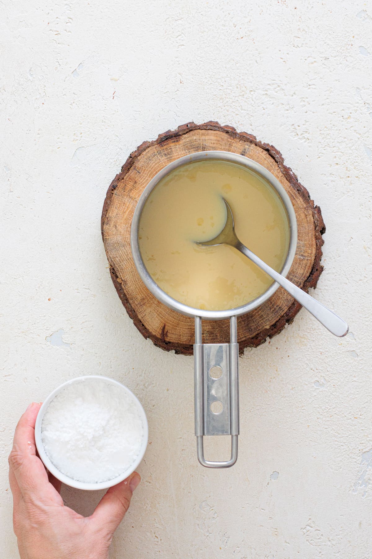 Melt butter with condensed milk, then add powdered sugar.