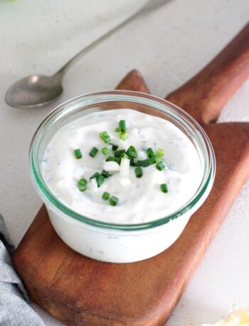 Creamy homemade yogurt ranch dressing topped with fresh chives.