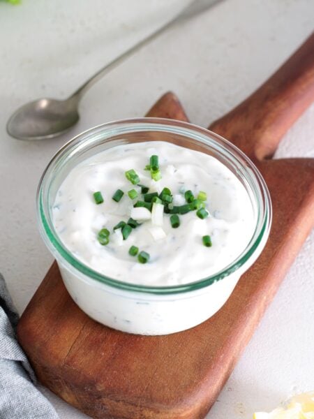 Creamy homemade yogurt ranch dressing topped with fresh chives.