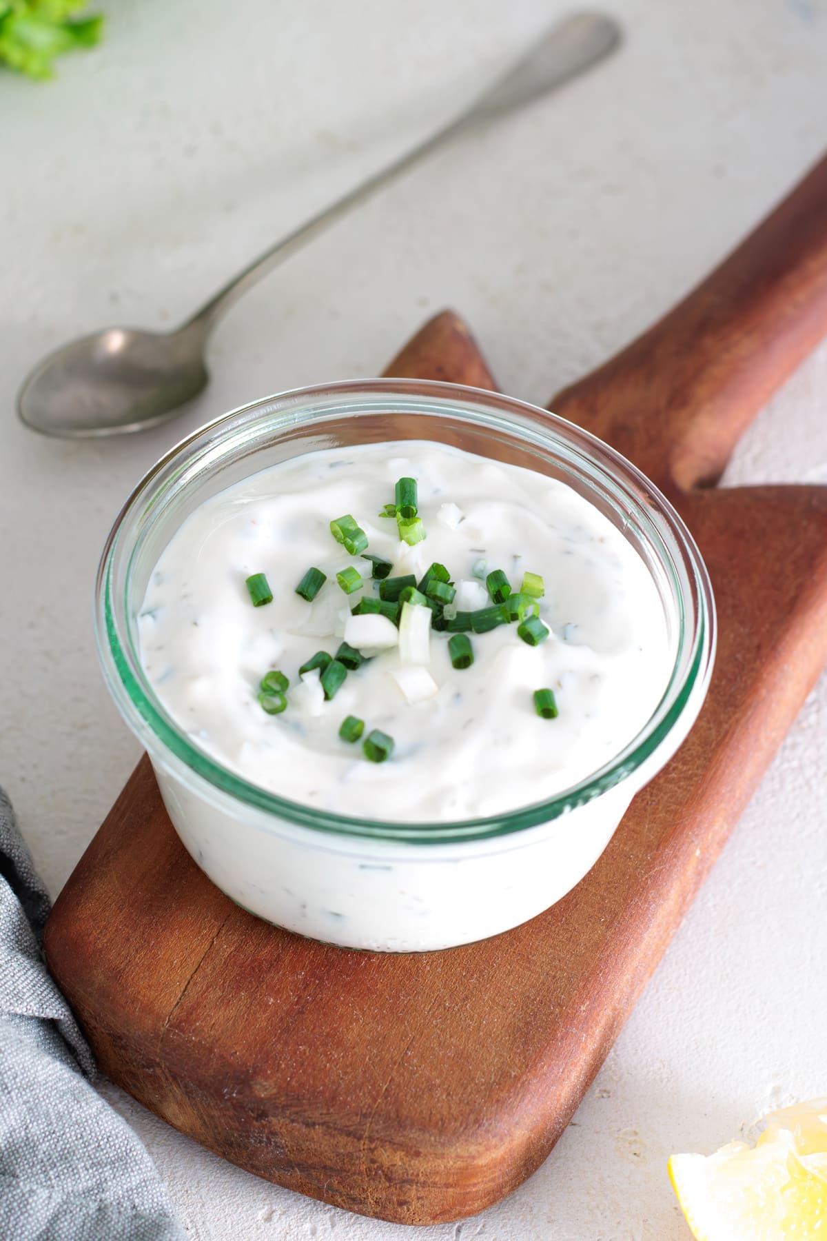Creamy homemade yogurt ranch dressing topped with fresh chives.