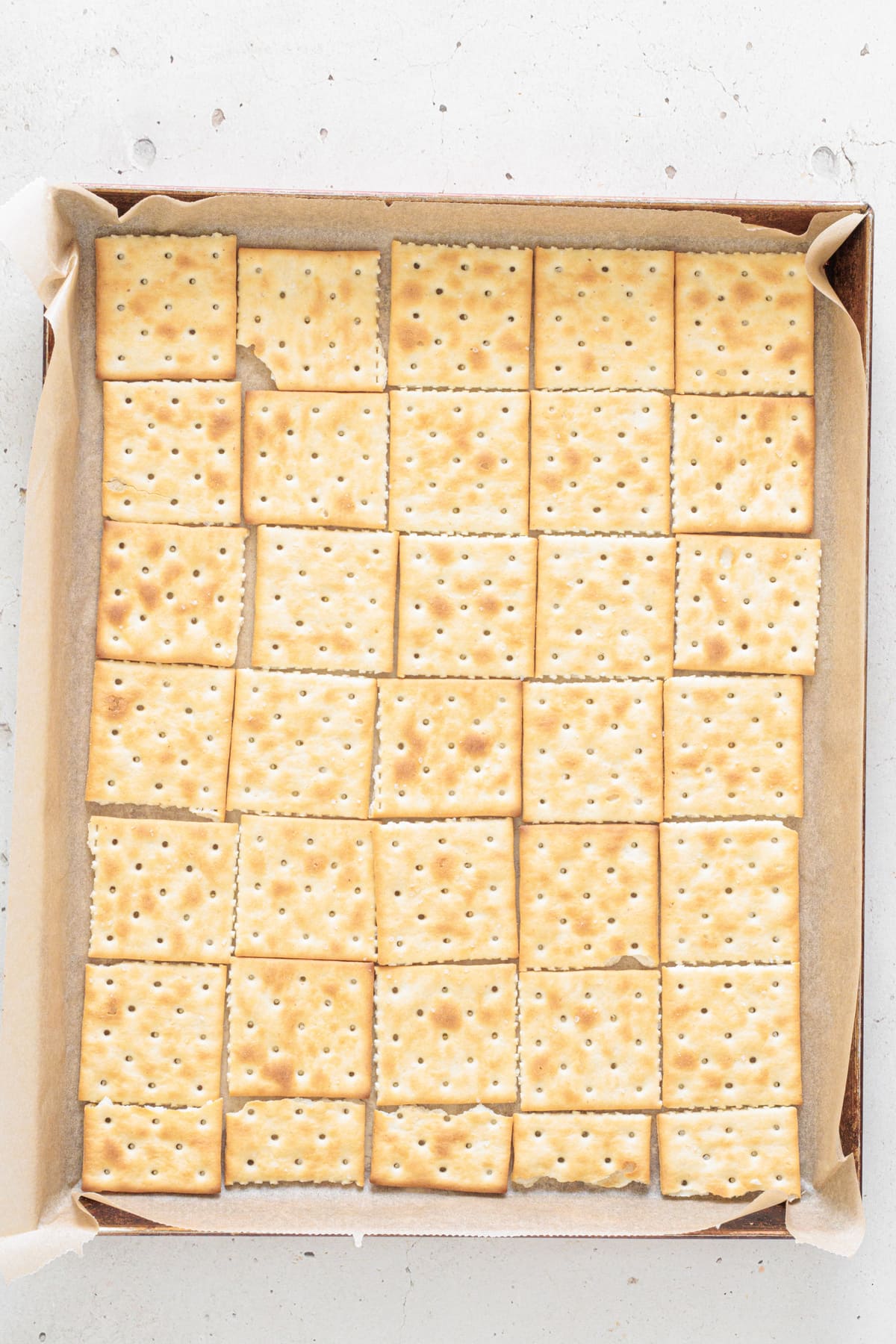 Crackers on parchment-lined tray.