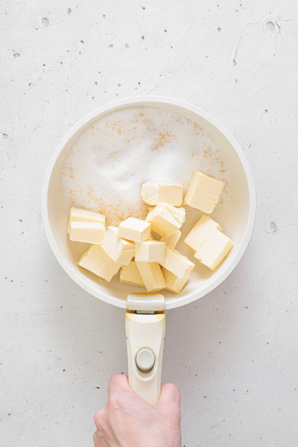 Melting butter and sugar in saucepan.