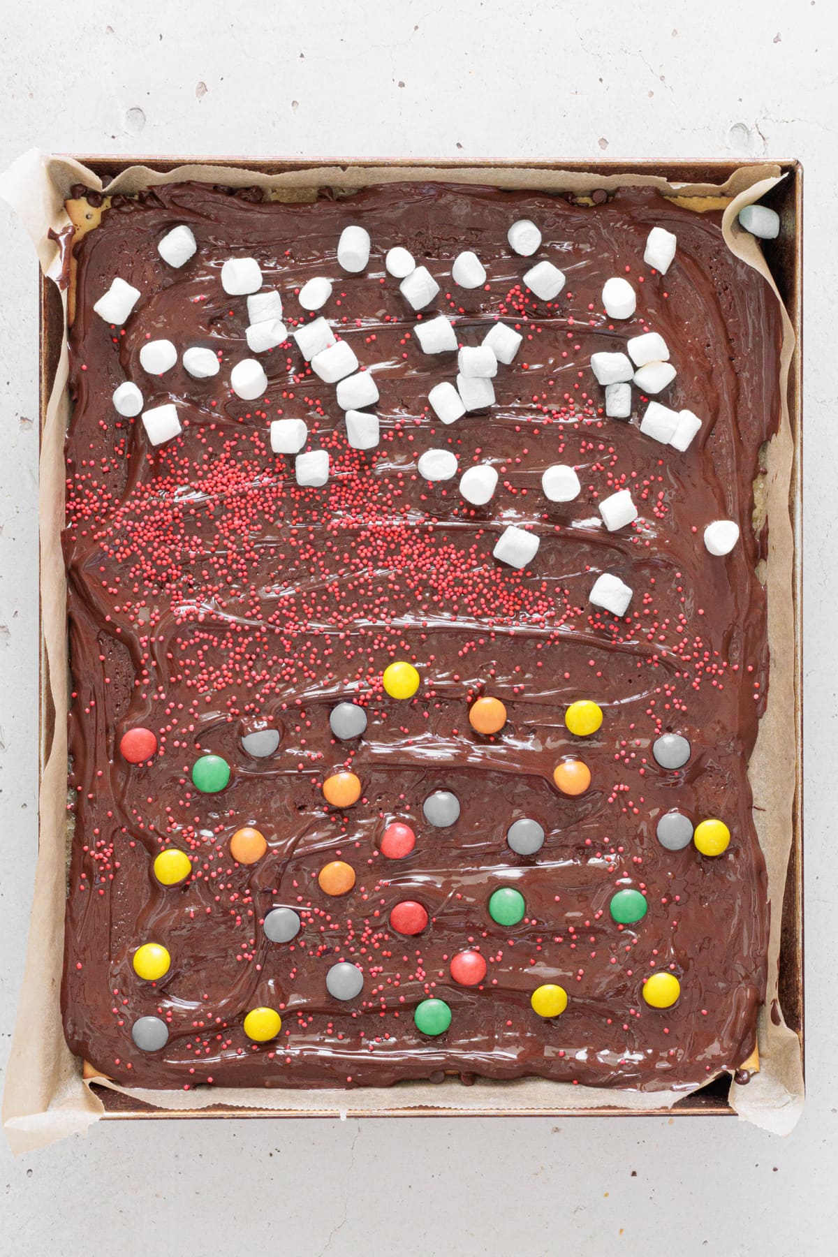 Toffee topped with marshmallows and candies.