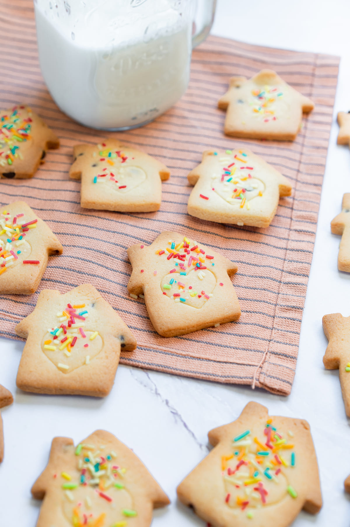 Freshly baked Christmas cookies with sprinkles, ready to enjoy with milk.