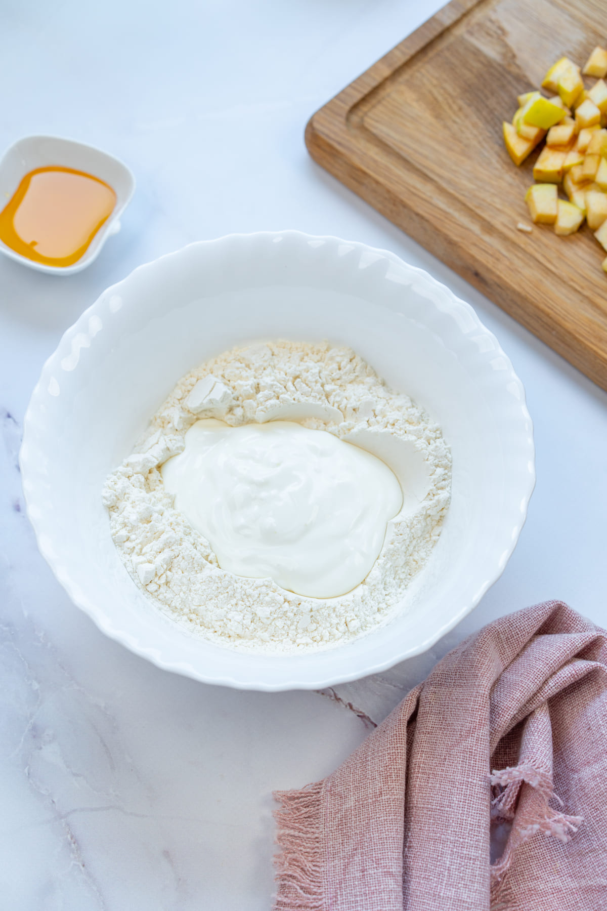 Mixing flour and Greek yogurt in a bowl for dough