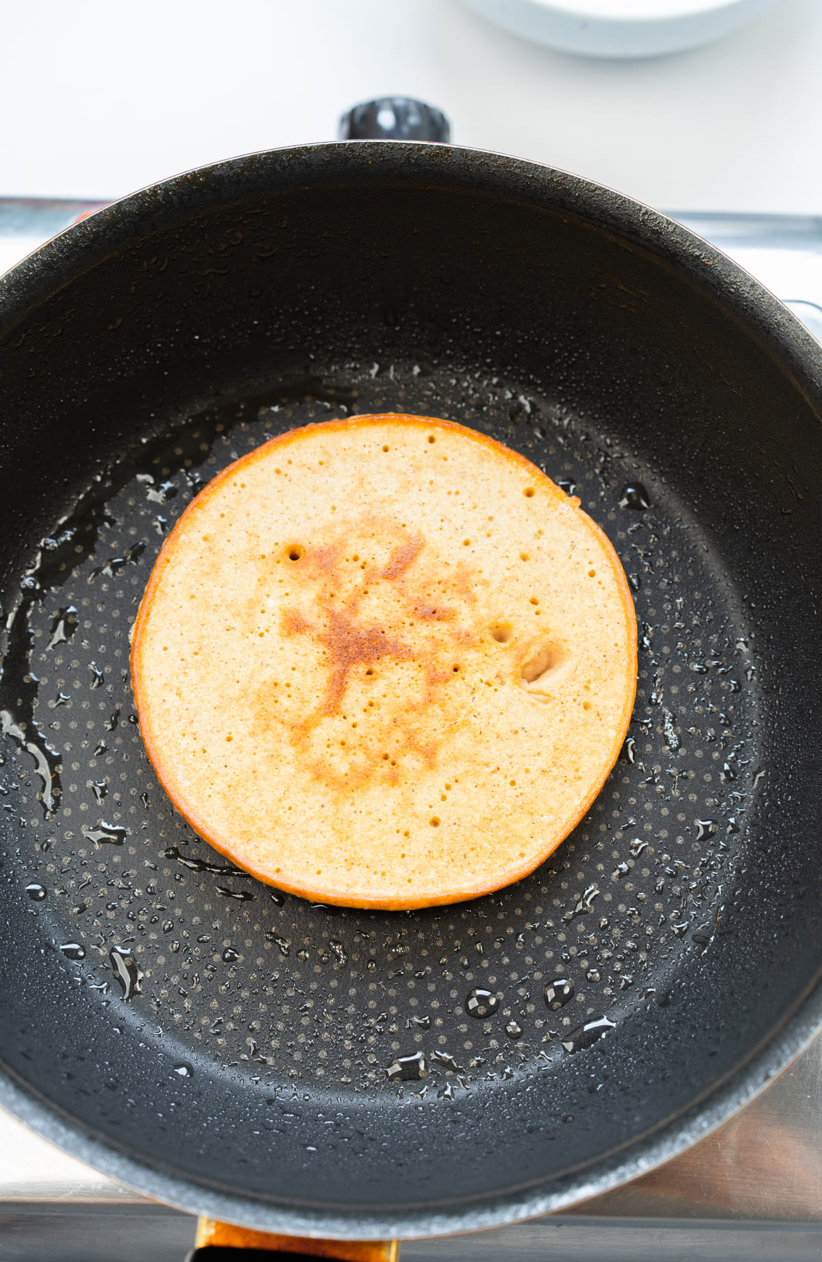 Flip the pancake once bubbles form and cook until golden.