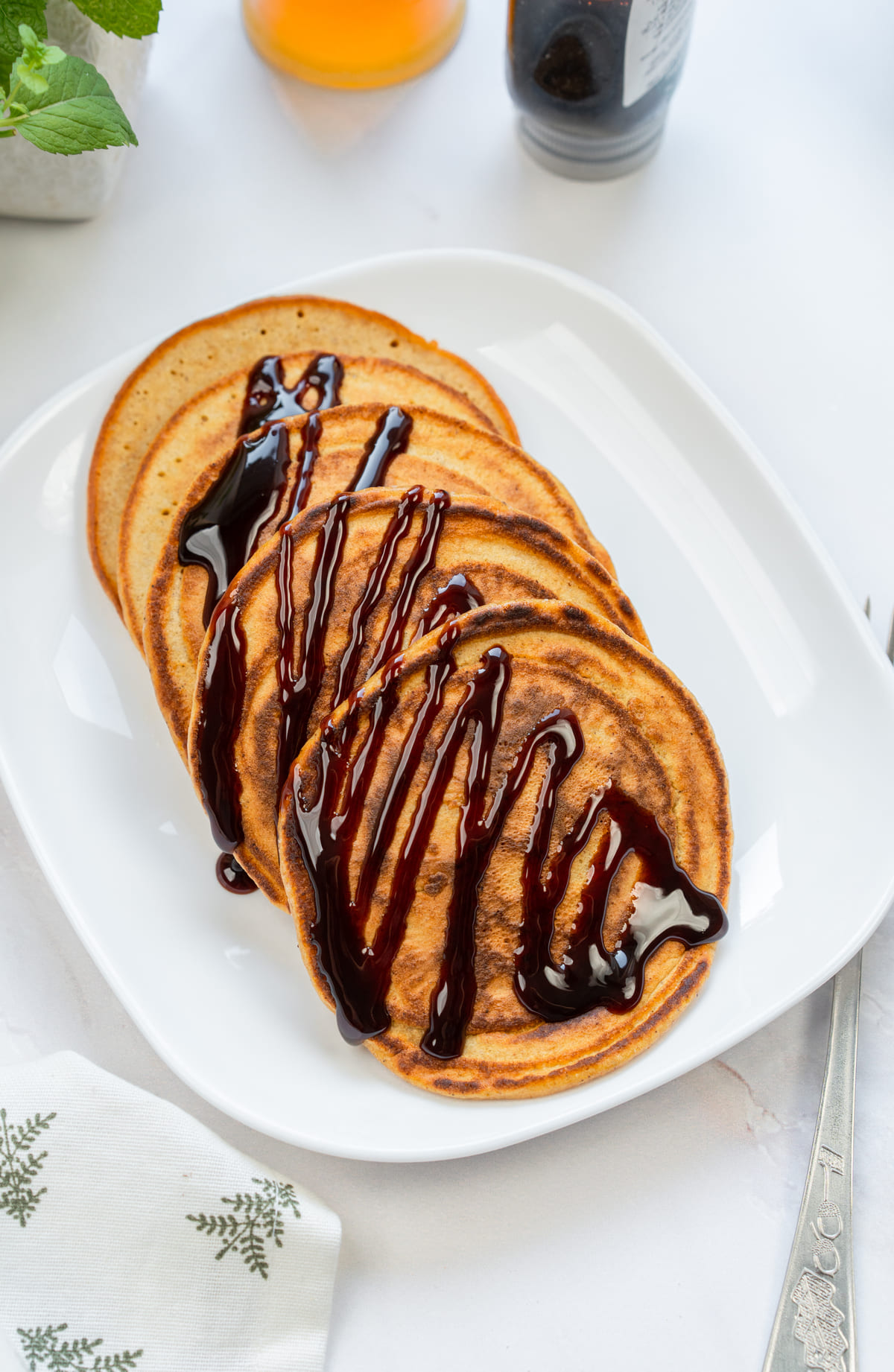 Fluffy Pumpkin Pancakes topped with chocolate sauce.