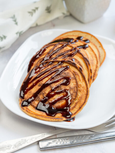 3-Ingredient Pumpkin Pancakes with chocolate drizzle.