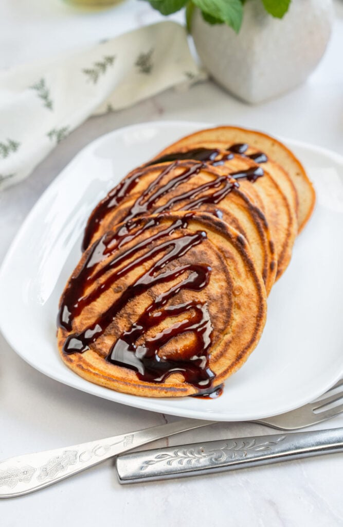 3-Ingredient Pumpkin Pancakes with chocolate drizzle.