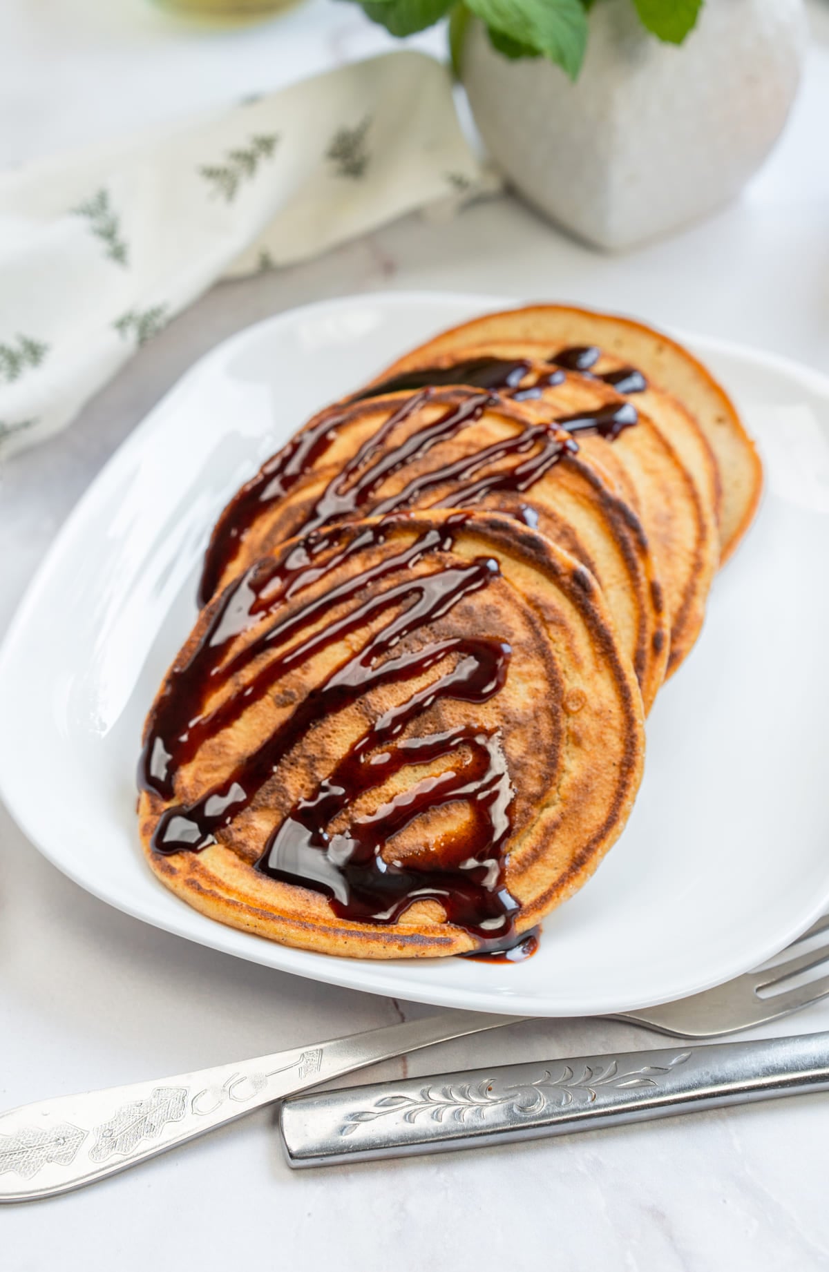 3-Ingredient Pumpkin Pancakes with chocolate drizzle.