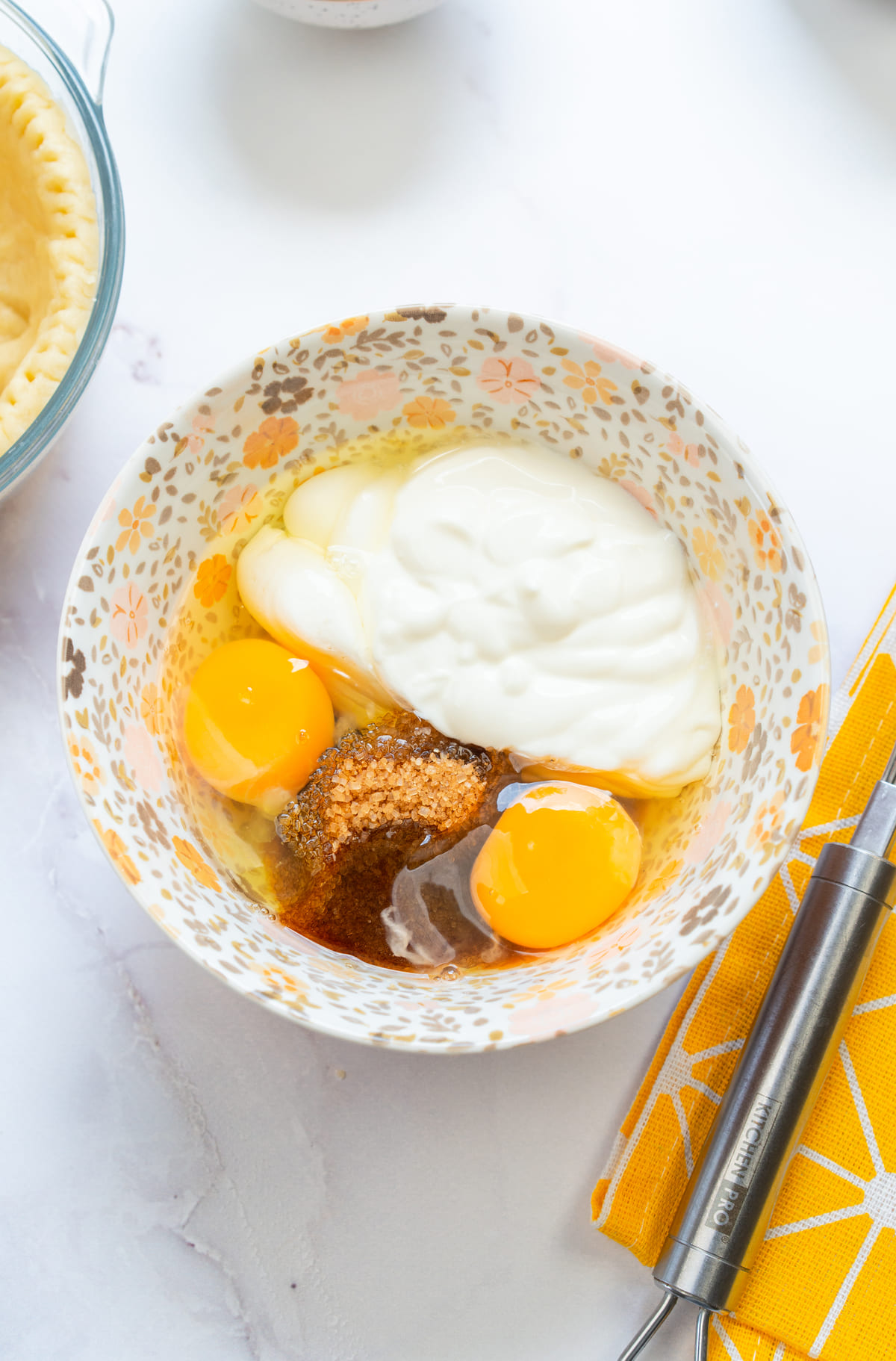 Whisking eggs, sugar, and cream for the filling.