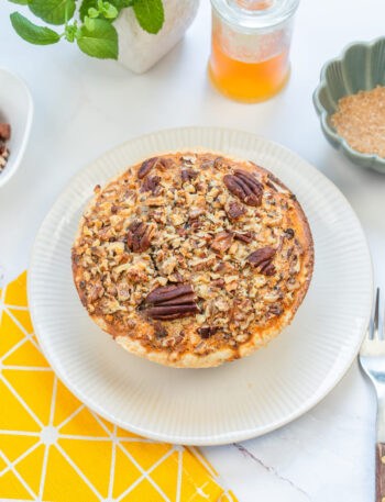 Gluten-free pecan pie served whole, topped with toasted pecans for extra crunch.