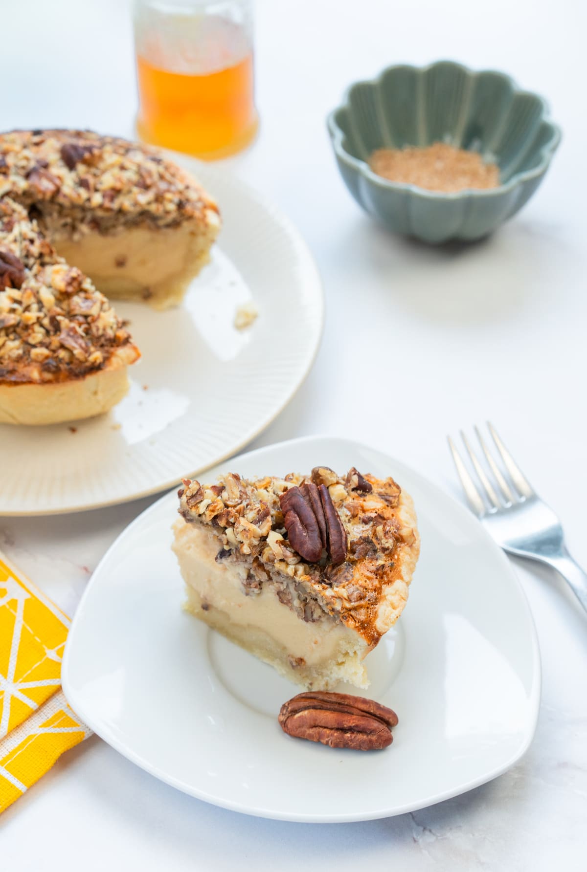 A generous slice of gluten-free pecan pie, perfect for holiday dessert tables.