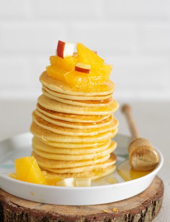 Gluten-Free Buttermilk Pancakes served with fresh orange and apple pieces for a bright finish.