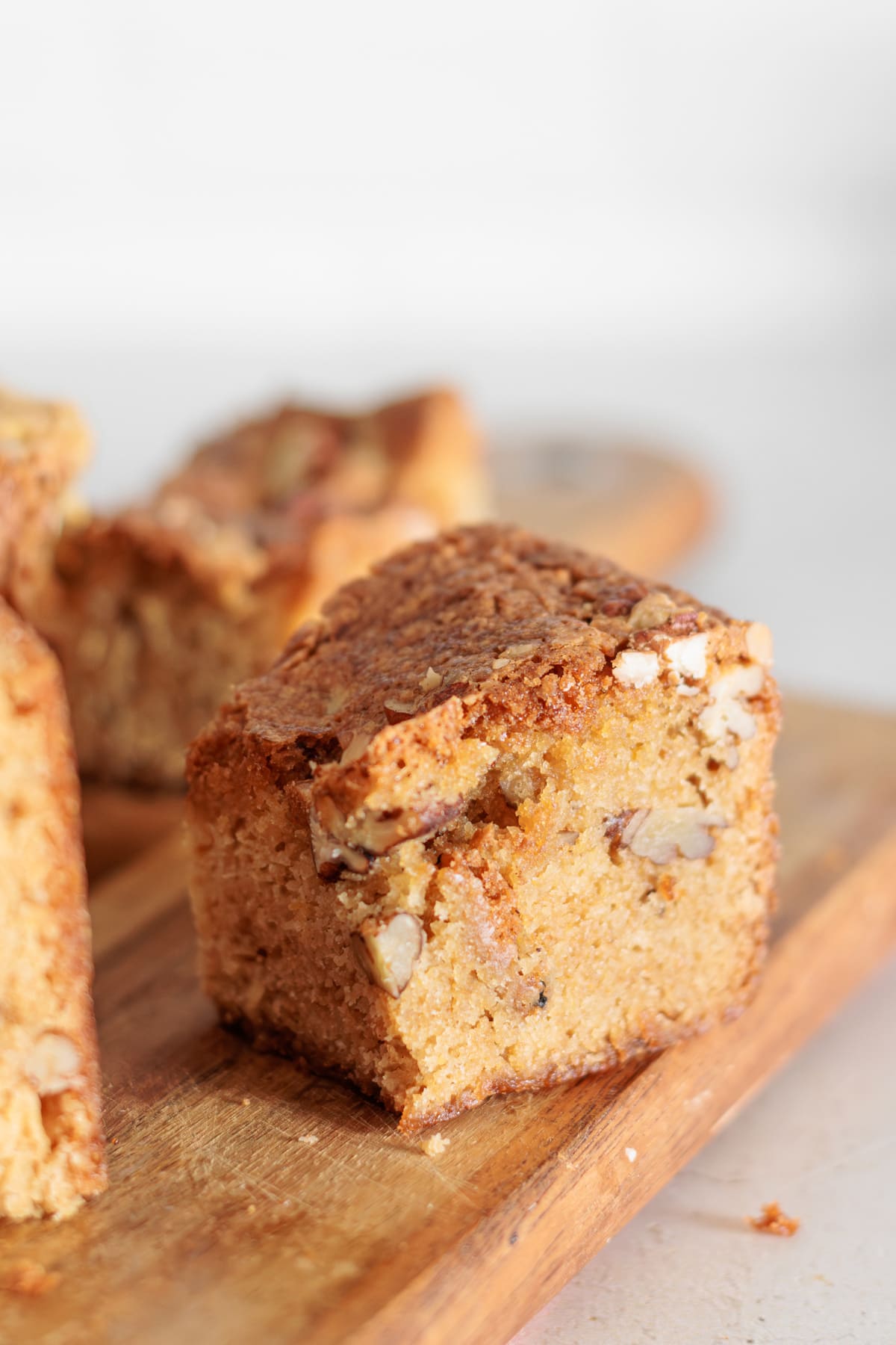 Close-up of a maple pecan blondie bar with a chewy texture and crunchy pecans.