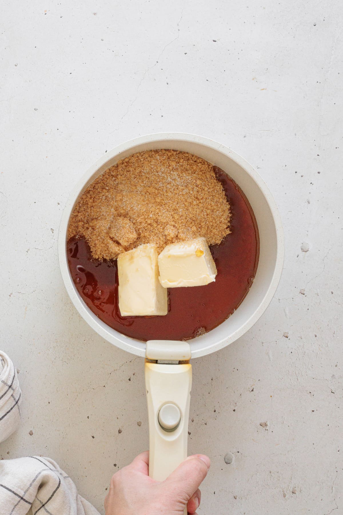 Butter, brown sugar, and maple syrup in a saucepan before melting