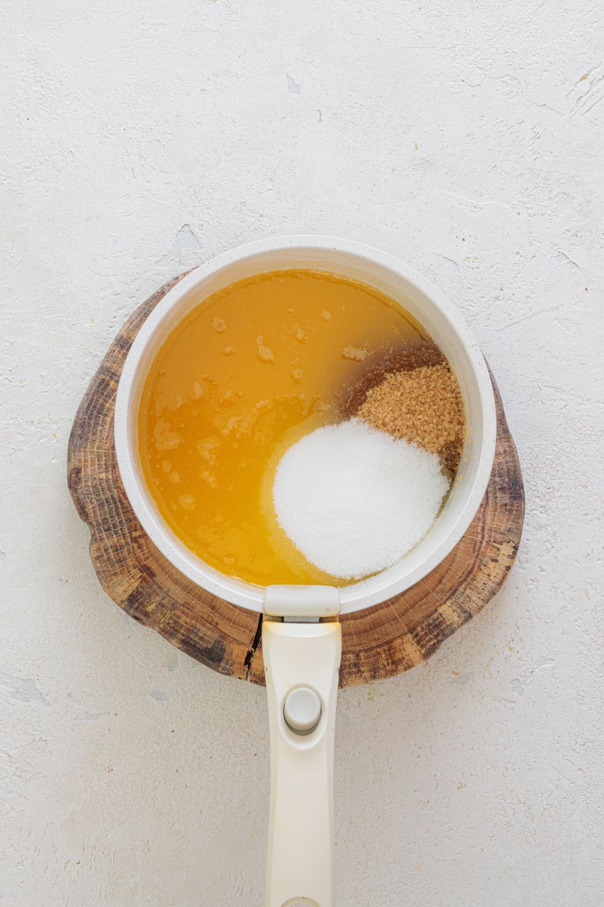 Melted browned butter in a saucepan with white and brown sugar