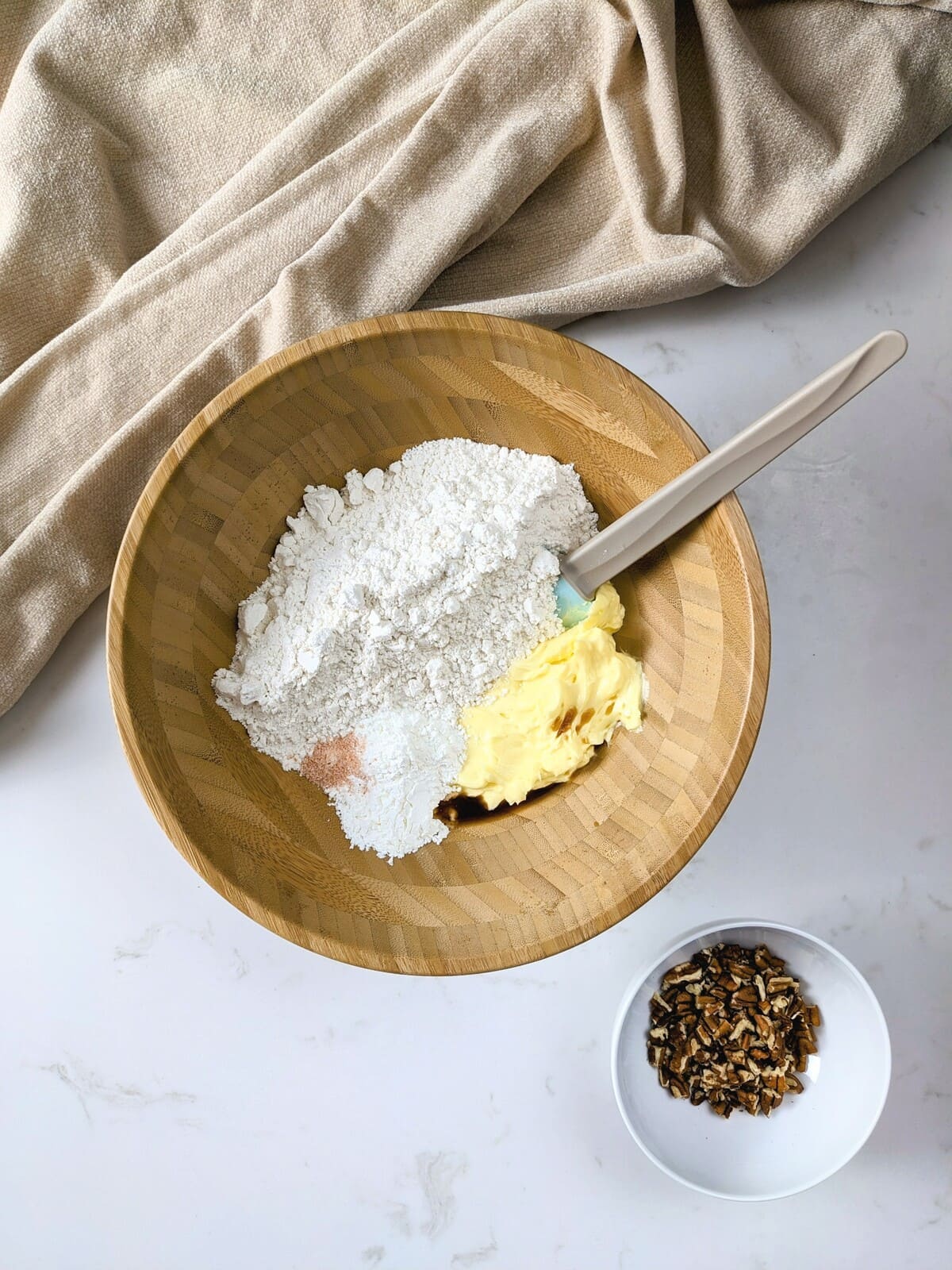 Mixing flour, butter, and salt in a bowl with a silicone spatula
