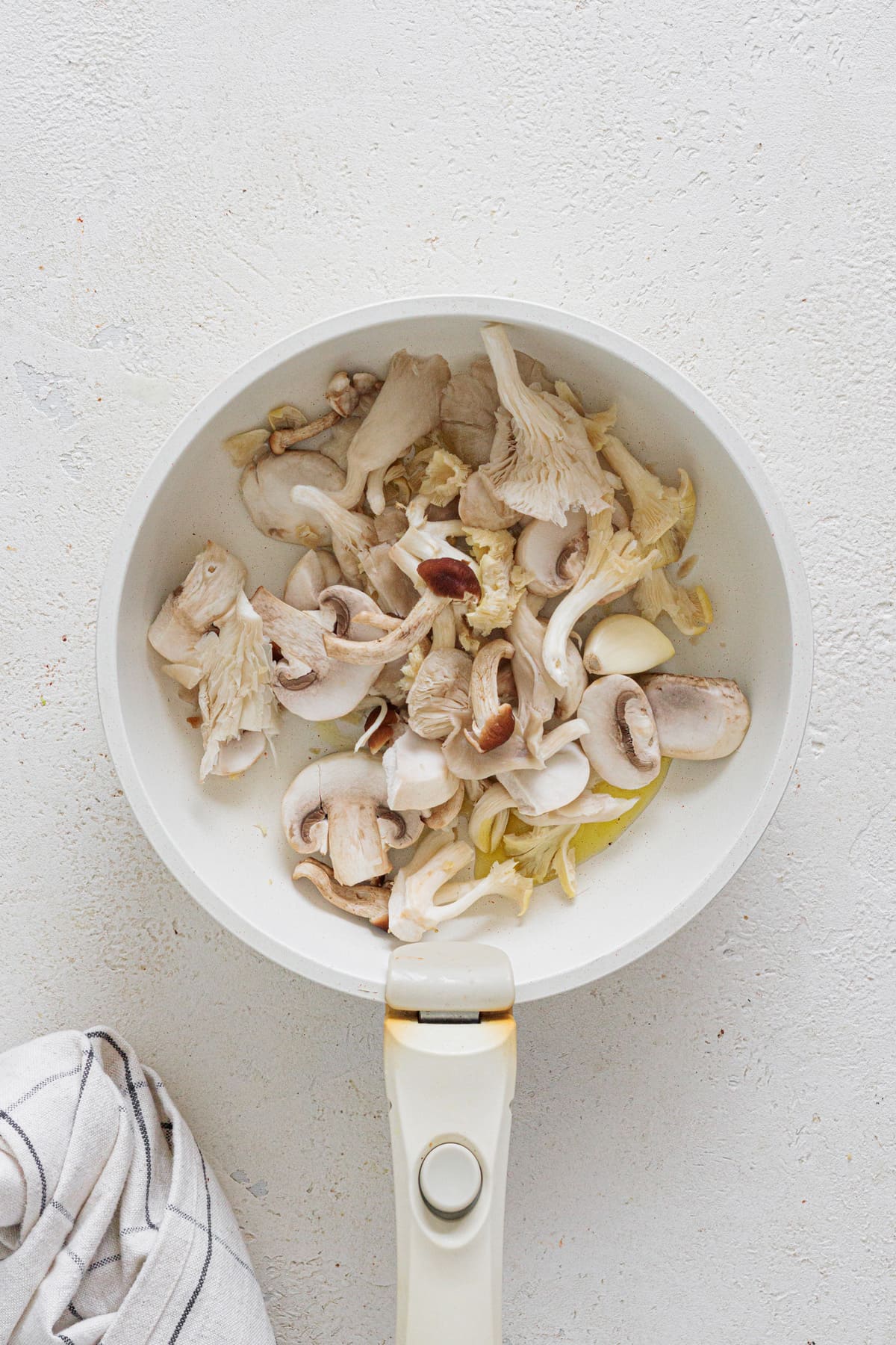 Mushrooms and garlic in a pan with olive oil before cooking