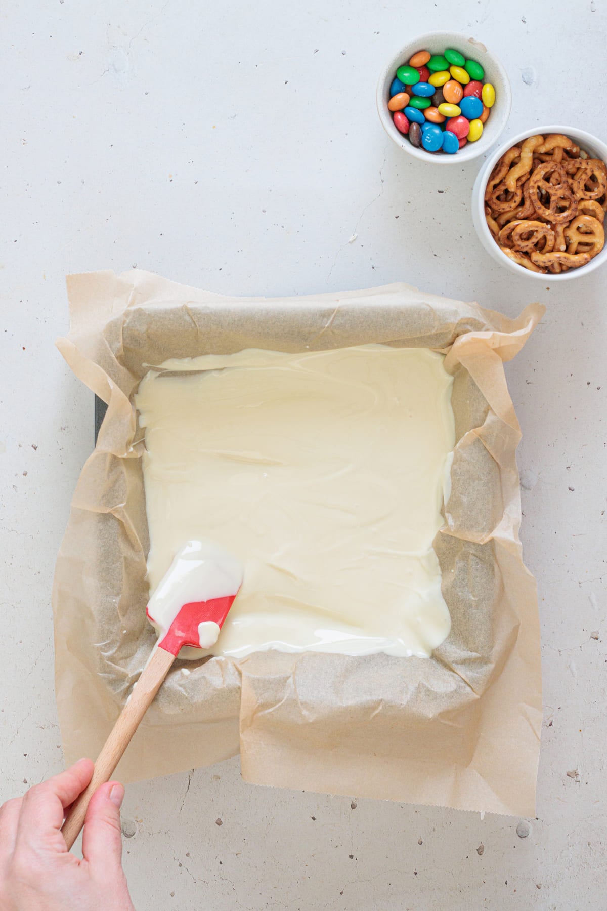 Spreading the melted white chocolate.