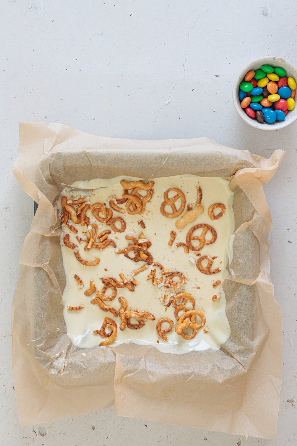 Add crushed pretzels on top of the white chocolate.