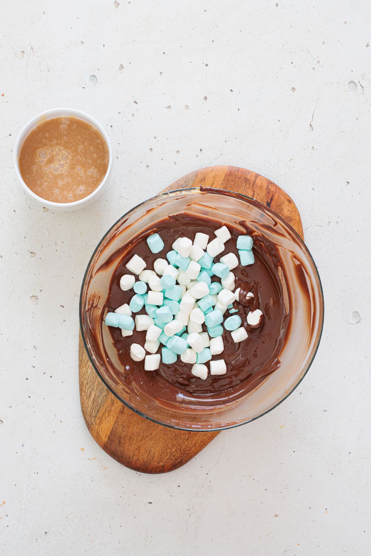 Add mini marshmallows to the melted chocolate.