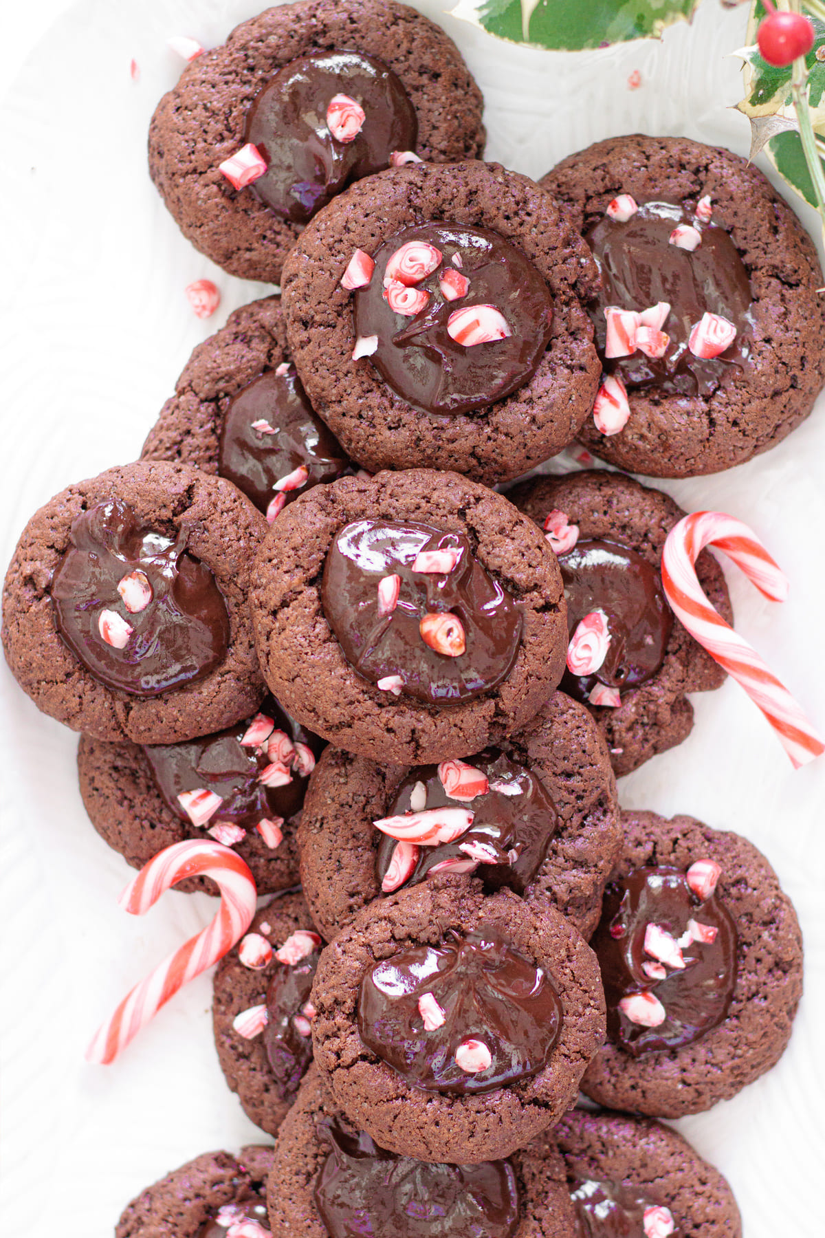 A platter of Chocolate thumbprint cookies topped with creamy ganache and crushed peppermint.