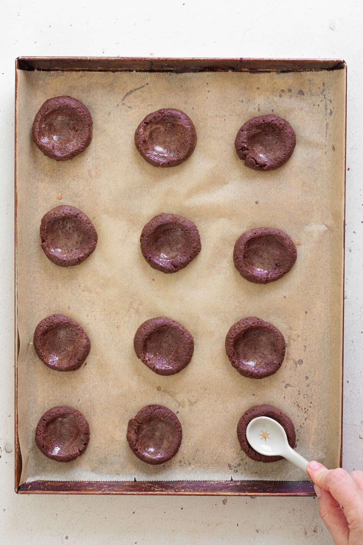 Shape the dough into balls and press the centers to form thumbprint wells.