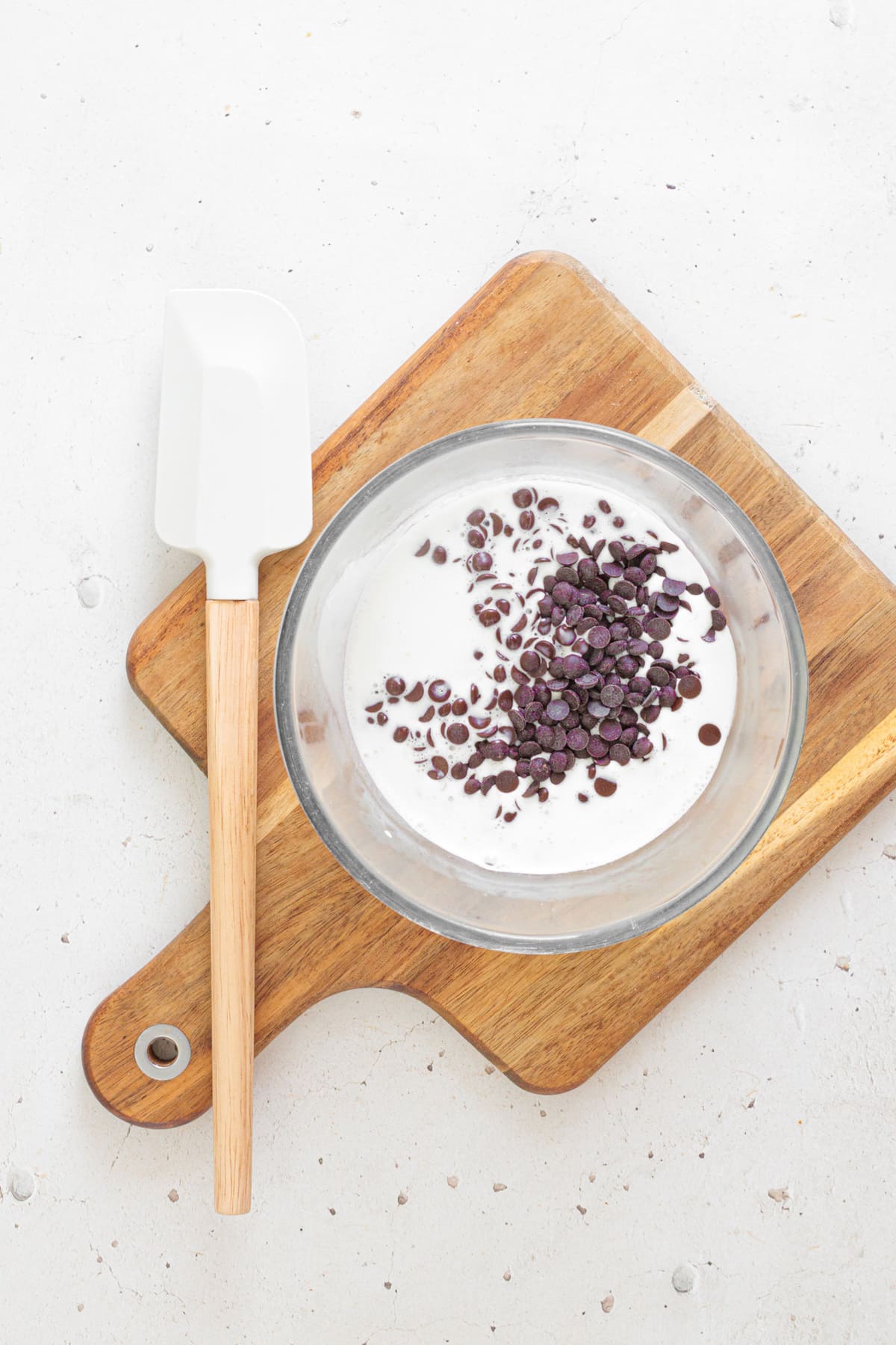 Pour the hot cream over the chocolate chips and let them sit for a minute.