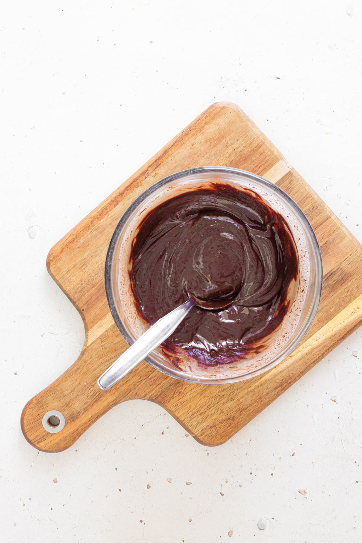 Stir the mixture until the ganache becomes smooth and glossy.